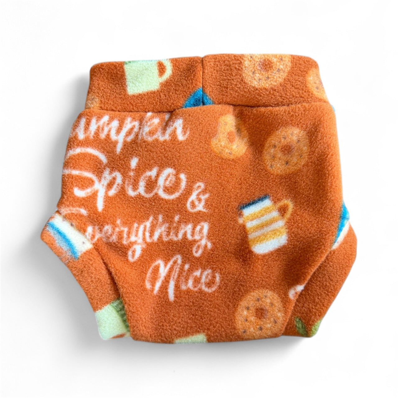 Orange fleece dog sweater with 'Pumpkin Spice & Everything Nice' text and coffee cup design on a white background